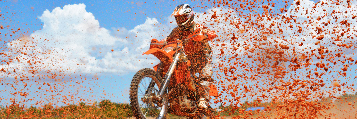 Dirtbiker riding through puddles