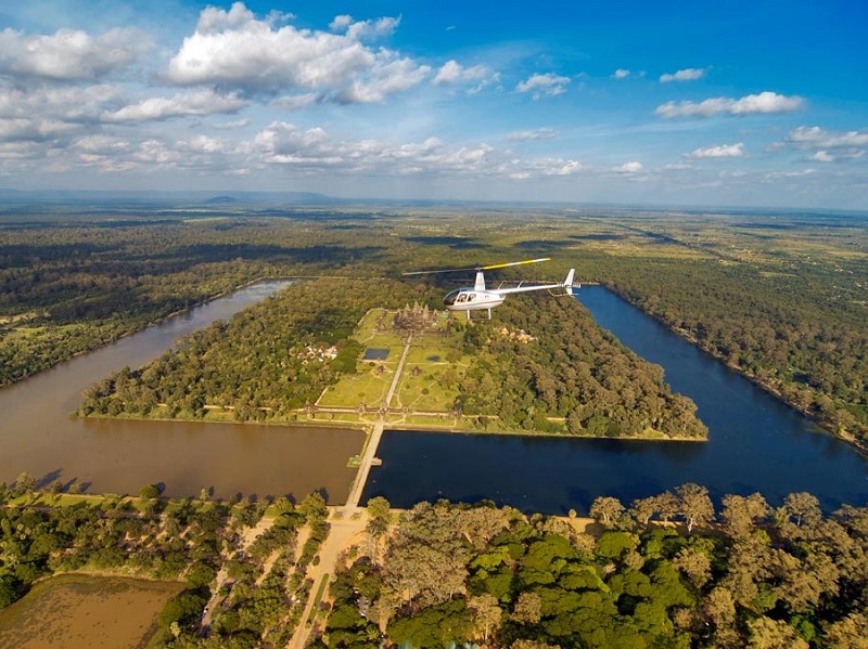 Helicopter flying over Angkor Wat