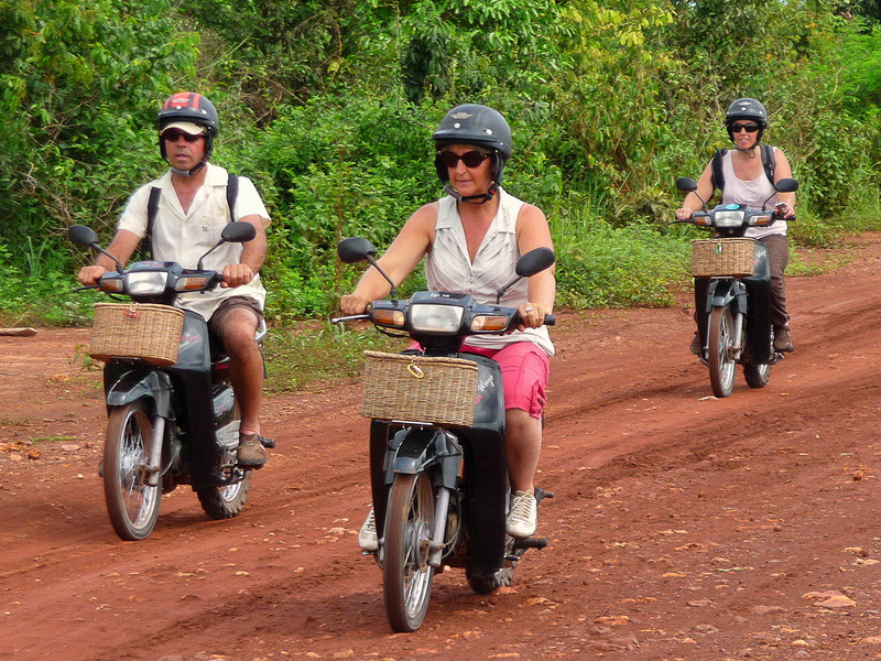 Tourists riding small motos