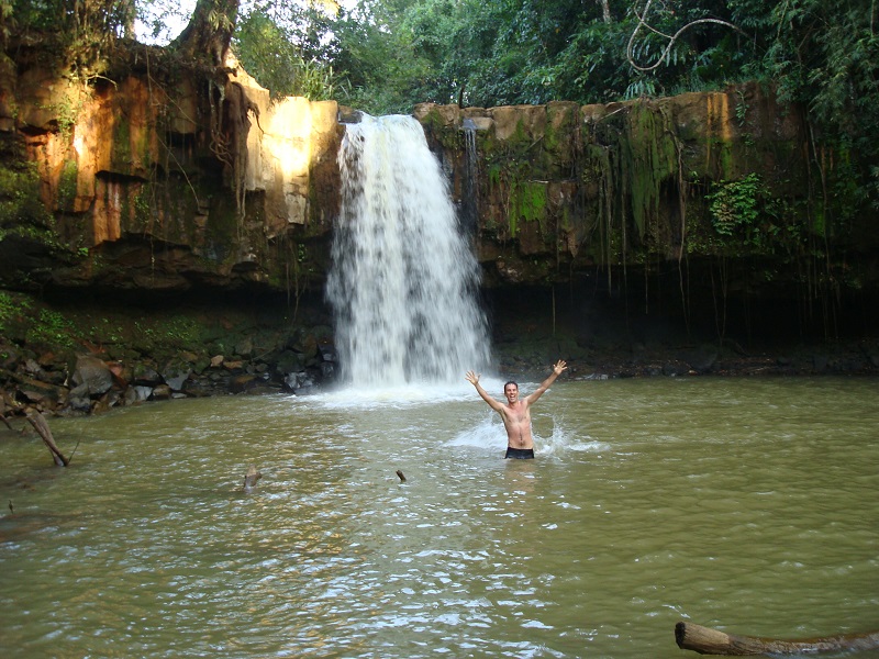 Man swimming in Sen Monorom waterfall