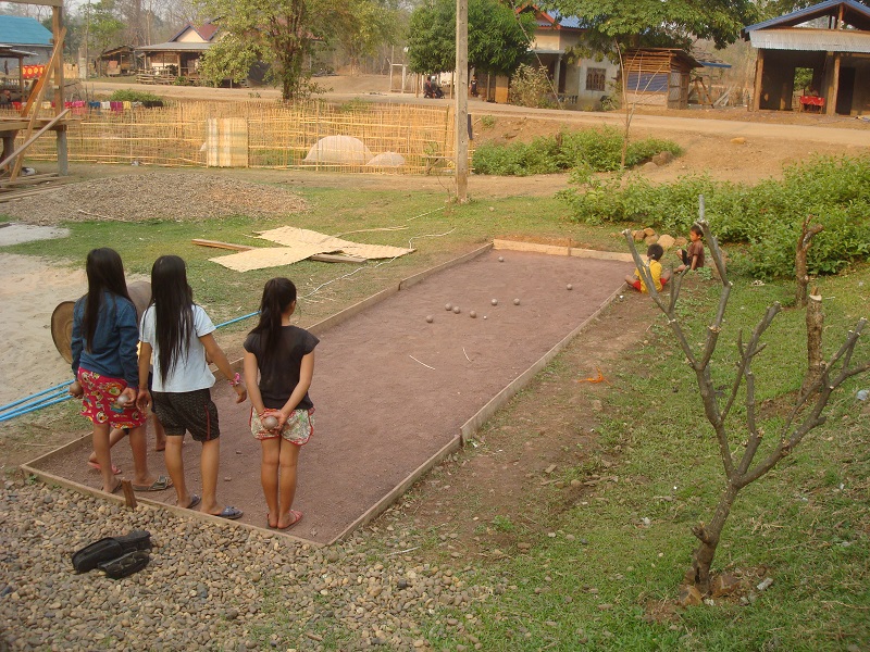 Laotian girls playing petanqe in Luang Prabang