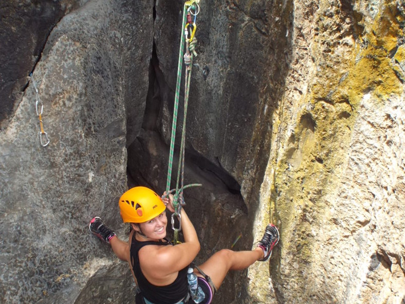 Woman rock climbing in Kampot