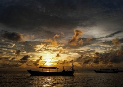 sunset over a fishing boat on the Tonle Sap lake
