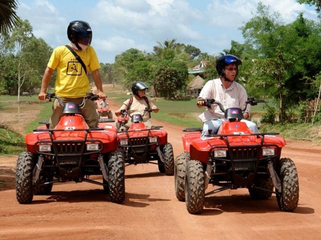 Tourists exploring the Cambodian countryside on 4x4 quad bikes