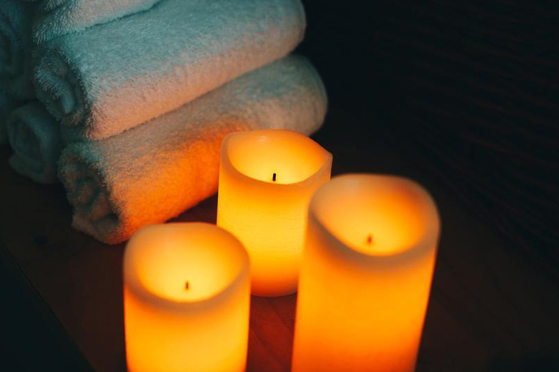 Lit candles and cold towels