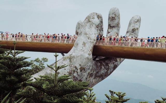 People standing on a Golden Bridge, Vietnam, Da Nang