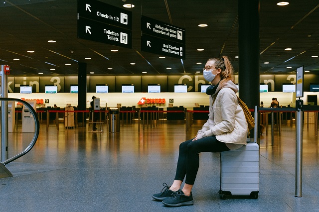girld waiting at airport during covid pandemic