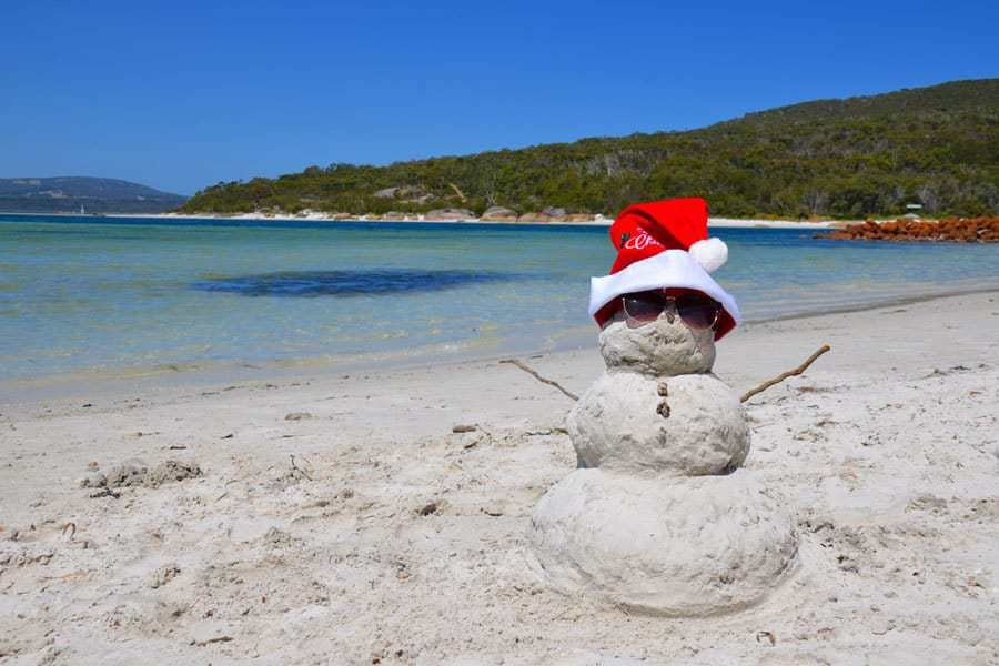 Snow man made of sand on a beach